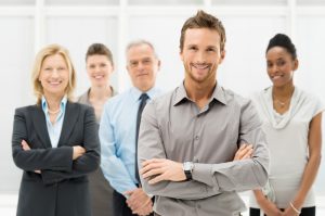 Q&A Portrait Of Young Businessman With Business Team