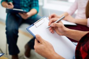 Career Psychologist making notes on paper sheet