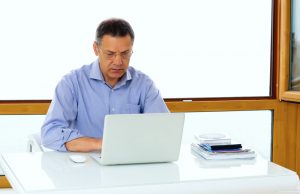mature man working and learning on his laptop computer