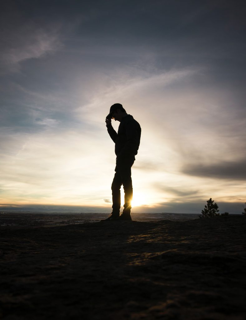 Man shown in silhouette feels sad after being fired