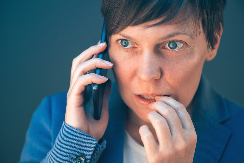phone anxiety shows on woman's face