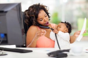 working moms talk on phone with baby and computer