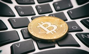 Blockchain is the technology of bitcoin (coin on keyboard)