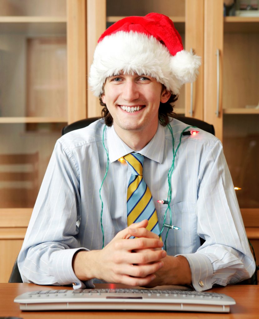 man in santa hat ready for holiday work party