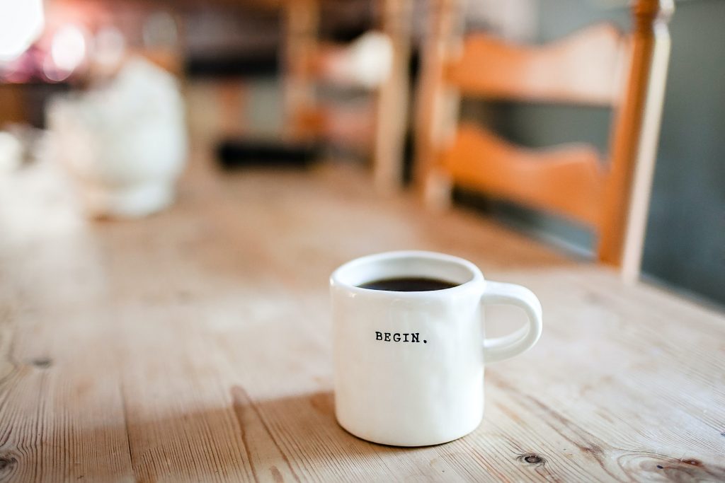 white mug that says begin