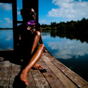 woman sits on dock recovering from burnout